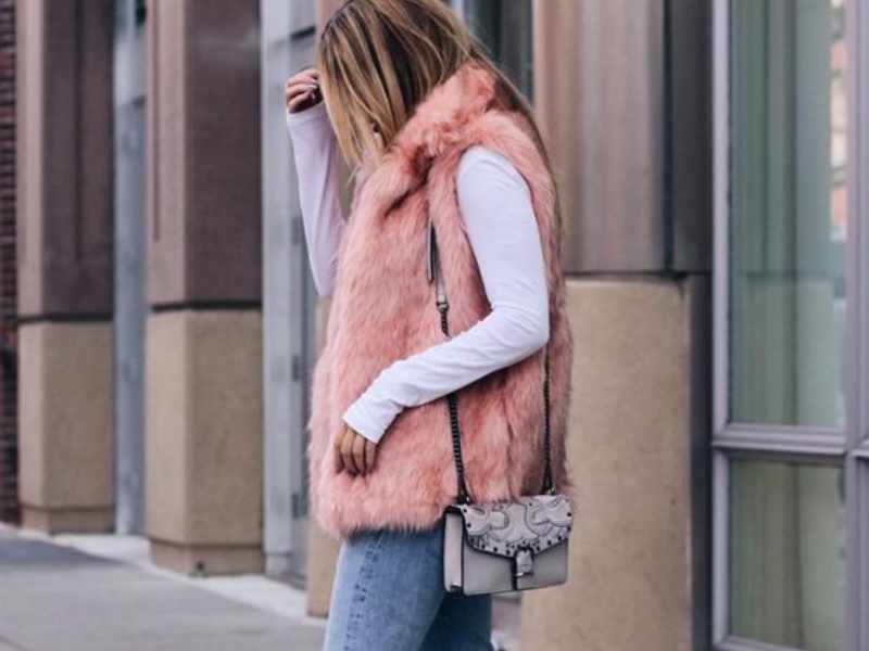 Faux Fur Vest Over a Lightweight Sweater as winter outfit ideas for women